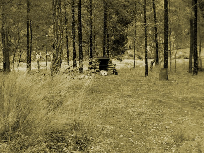 Campsite near the river with a fire place.